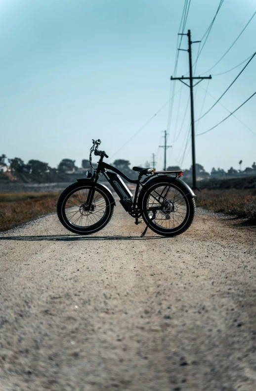 a bike is parked on a dirt road