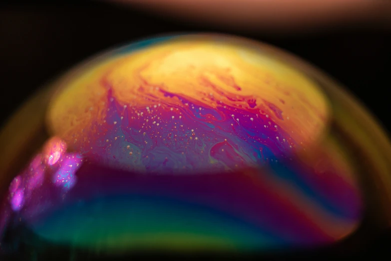 a close up of a multi - colored sphere with paint on it