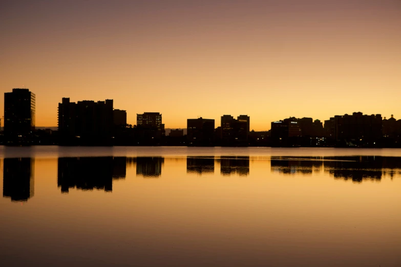 there is a city at dusk, a few buildings to the side