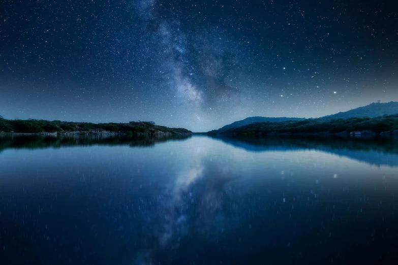 the night sky reflects in the still water