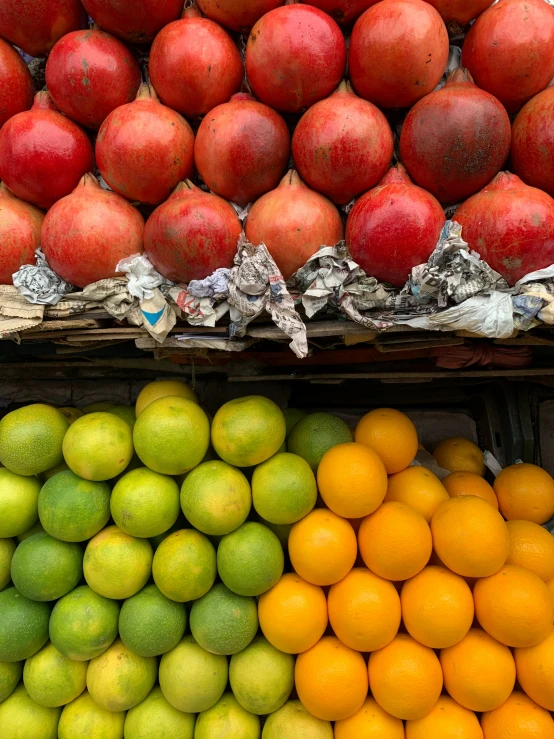 an assortment of fruits displayed with a newspaper lined shelf