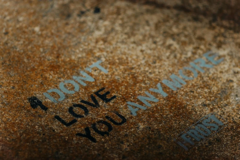 a rusty surface with blue writing on it