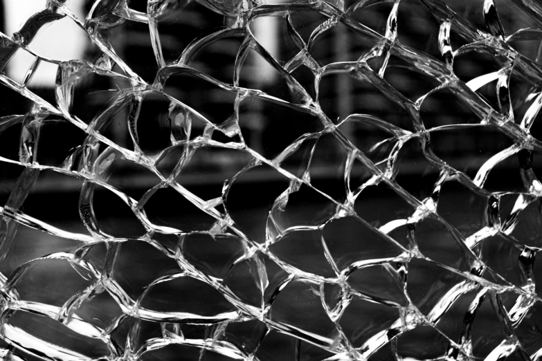 a broken glass window with a large piece of broken shattered glass