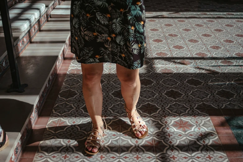 the sun shines on the shoes of a woman in sandals