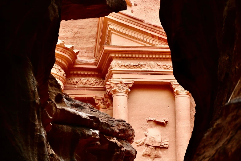 an arch in a stone structure that looks to be built into a cliff