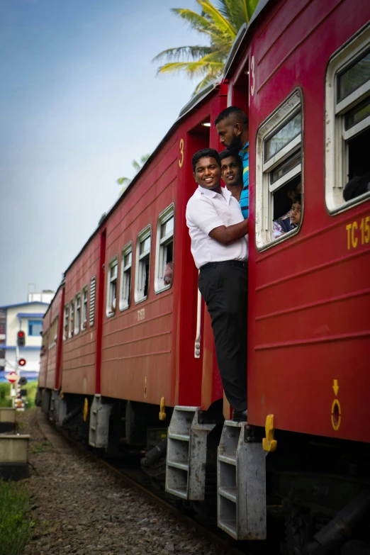 man and children stand on a train cart