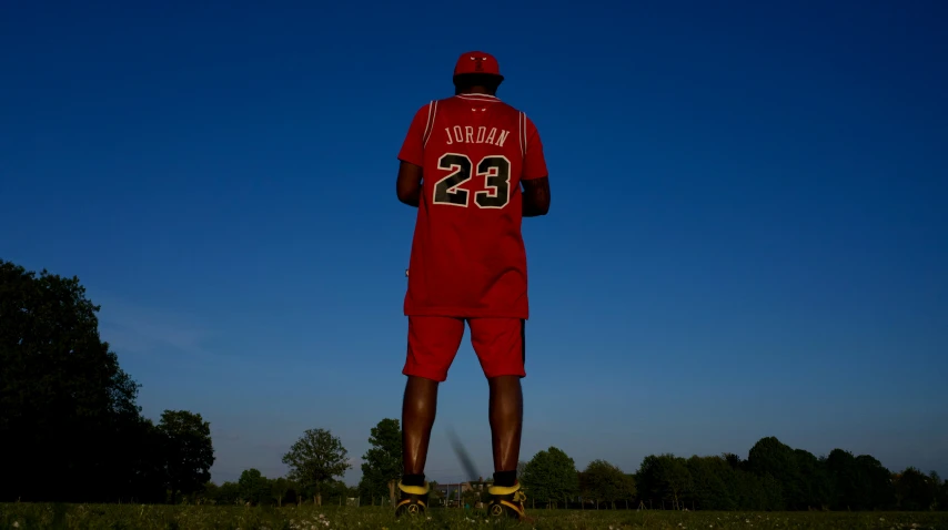 man in red jersey with number 23 on his body