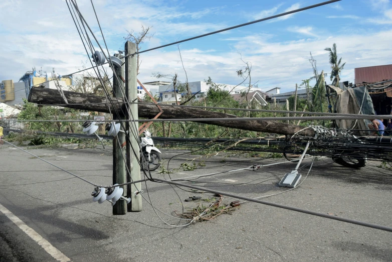 there is an overhead telephone pole that has fallen down