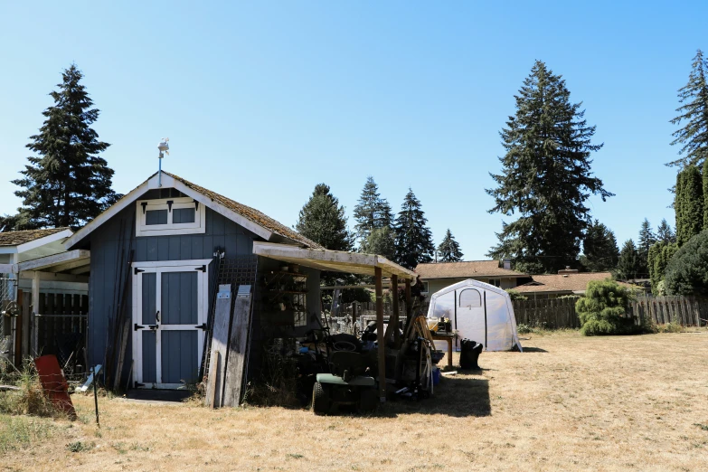 a yard with a shed and some doors