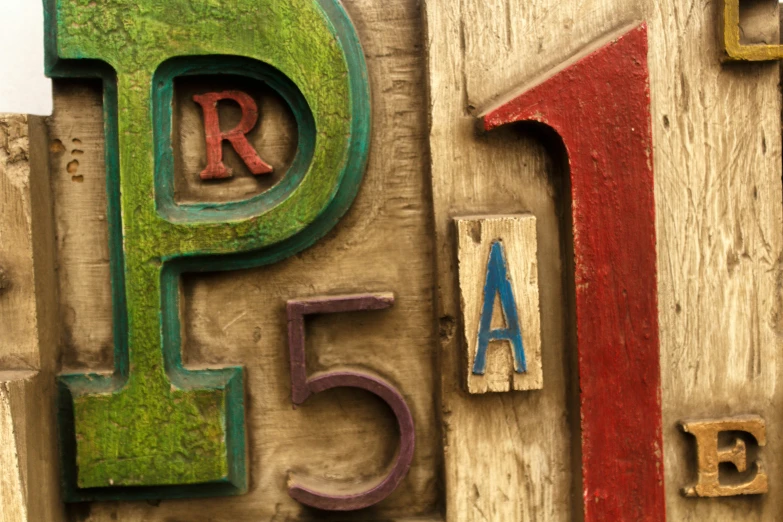 a wooden sign showing the letters of the alphabet