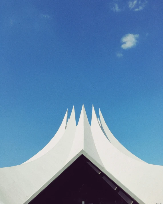 a large white building with a sky background