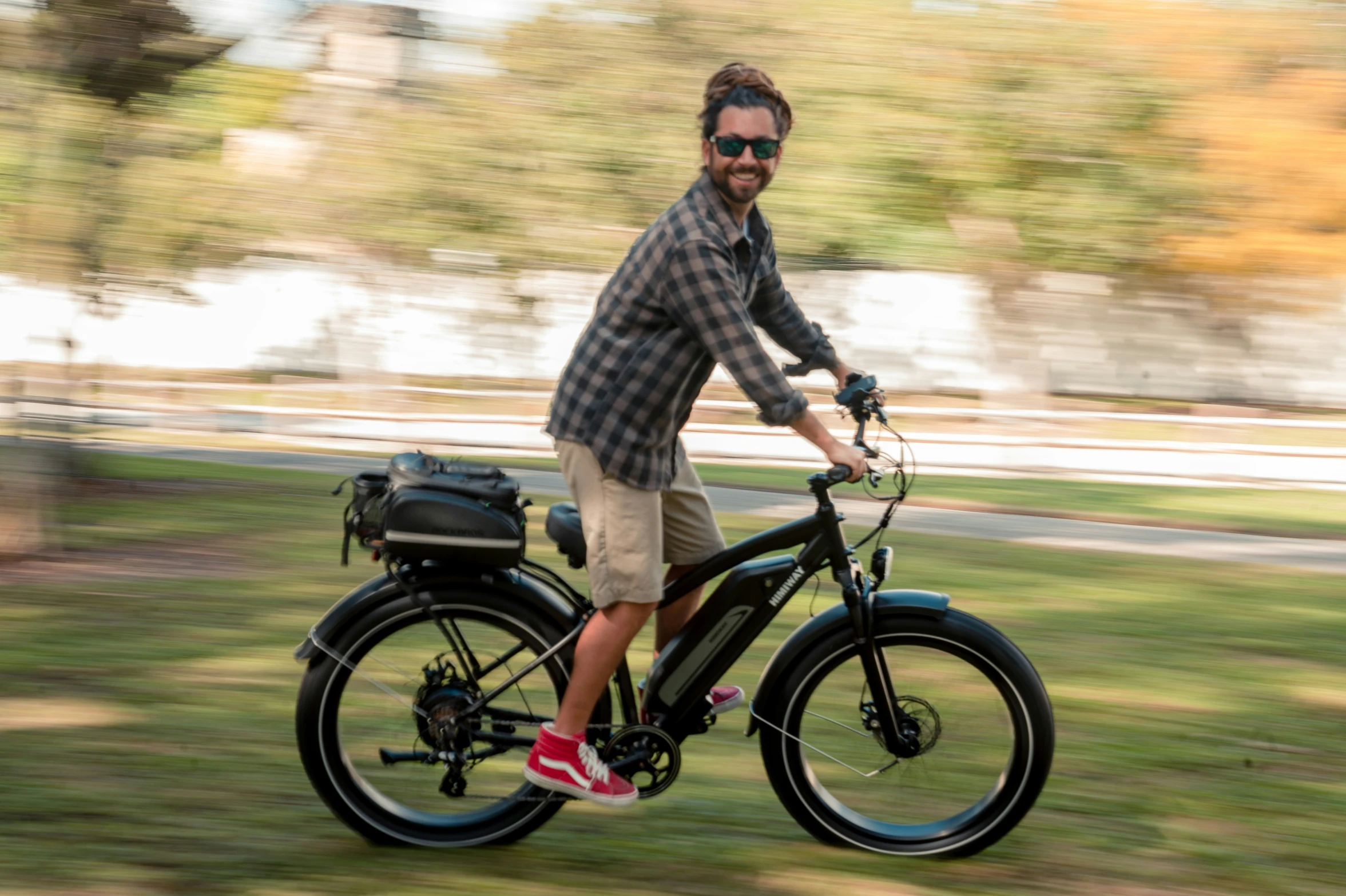 a man riding on the back of a black bike