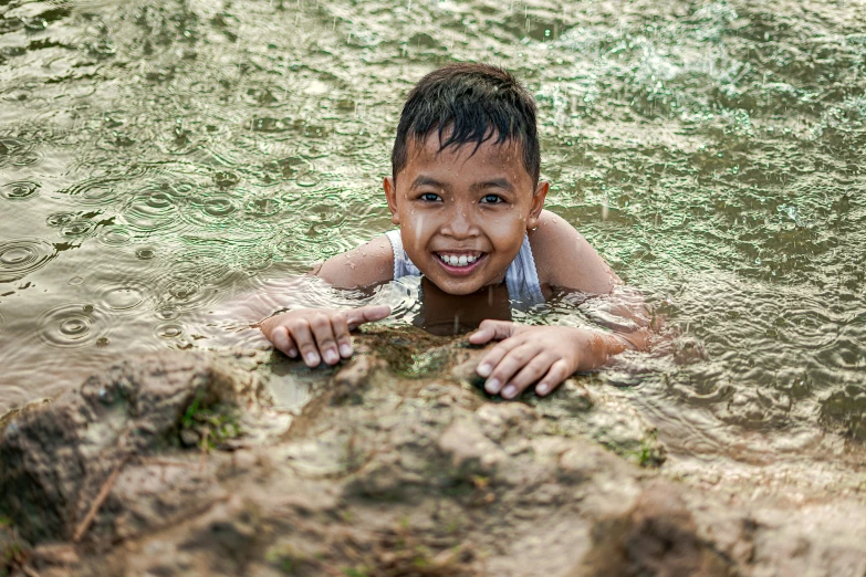 a  smiling while swimming in water