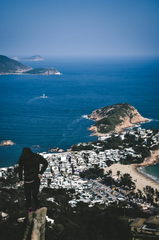 a man that is standing on top of a rock