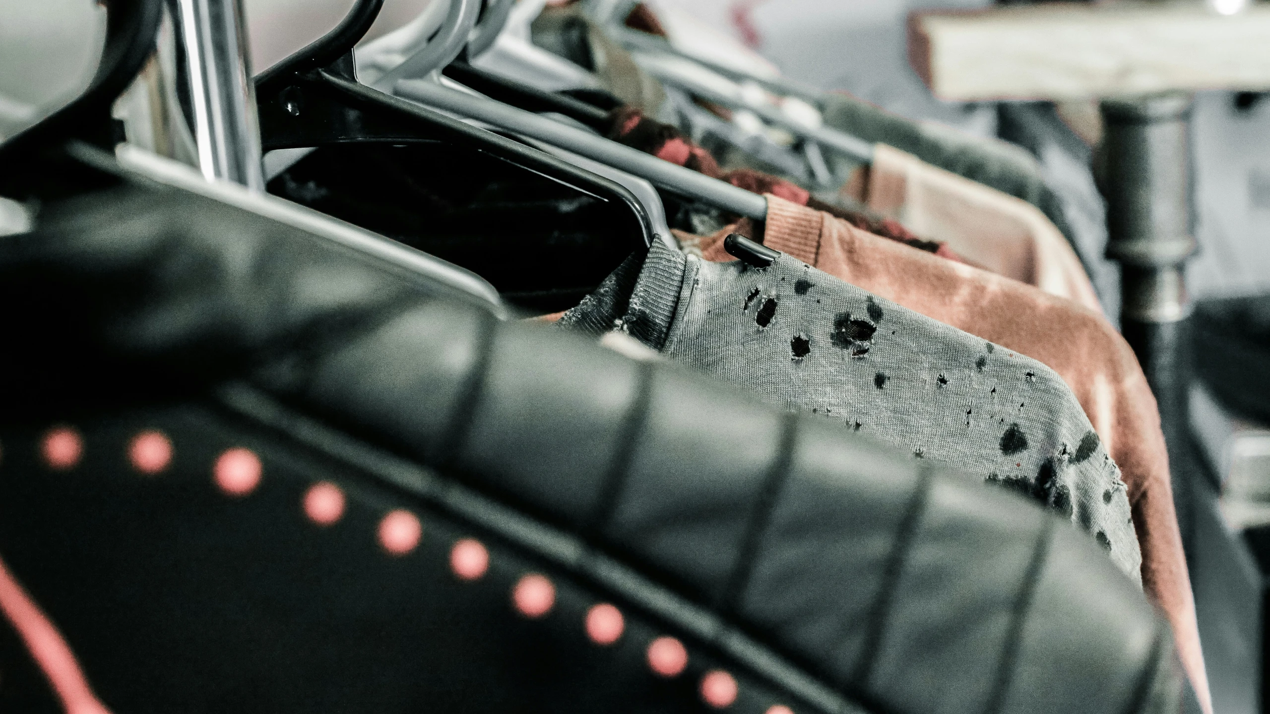 a close up of clothes hanging from a rack