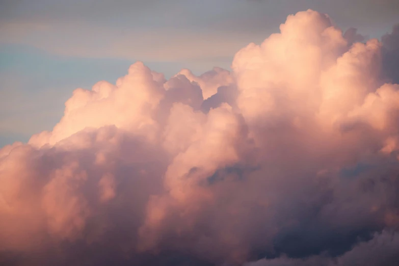 the sky is full of pink clouds as it begins to turn