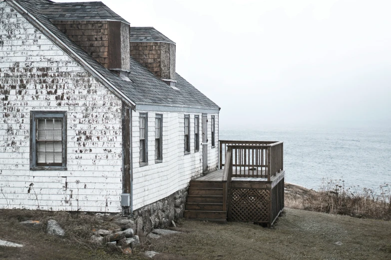 an old house on the coast of the ocean