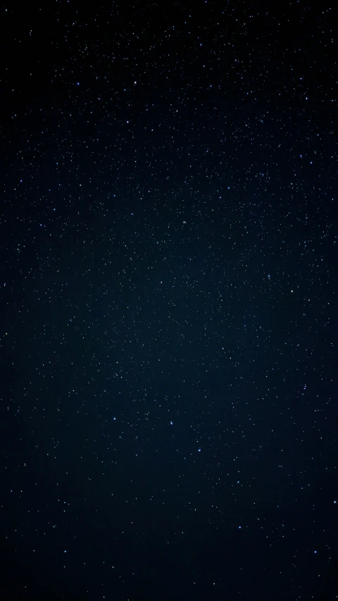 a large dark sky with white stars all around