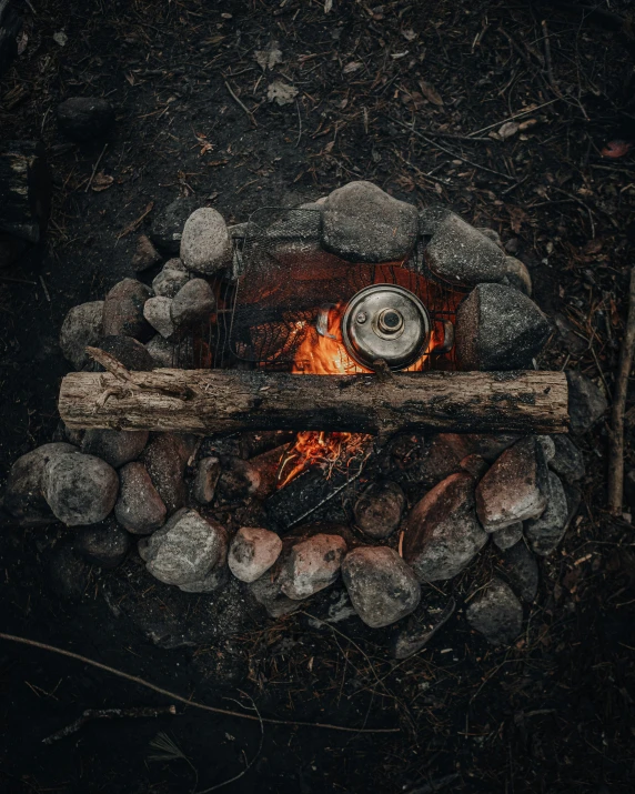 a wooden stick is sitting next to a campfire
