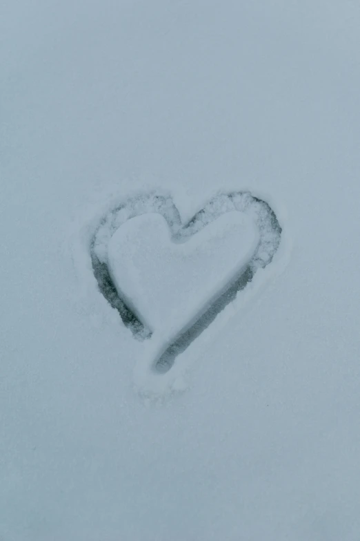 heart made from snow in the middle of a gray sky