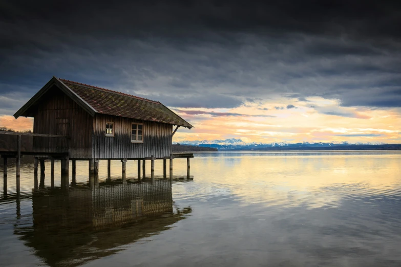 a picture taken from water level of a small house on dock