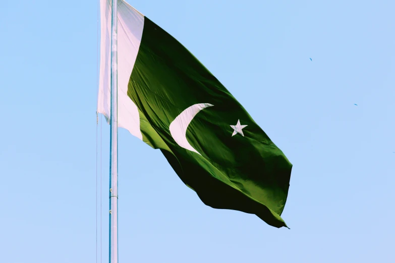 the pakistan flag waving in the wind in the sun