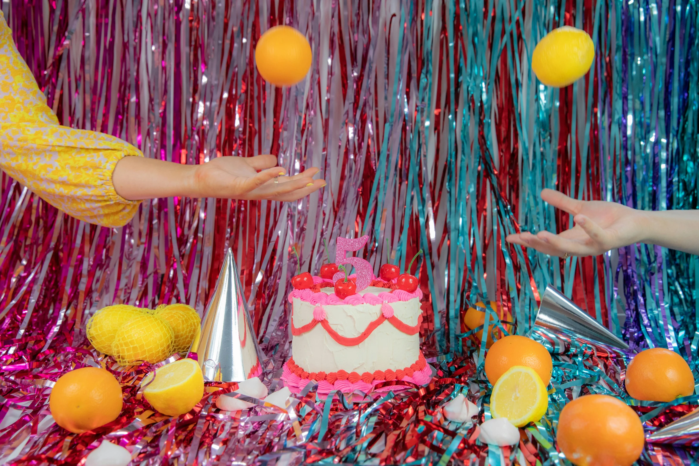 a woman is reaching for a birthday cake