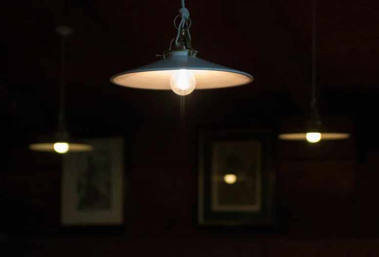 a dark room filled with hanging light bulbs