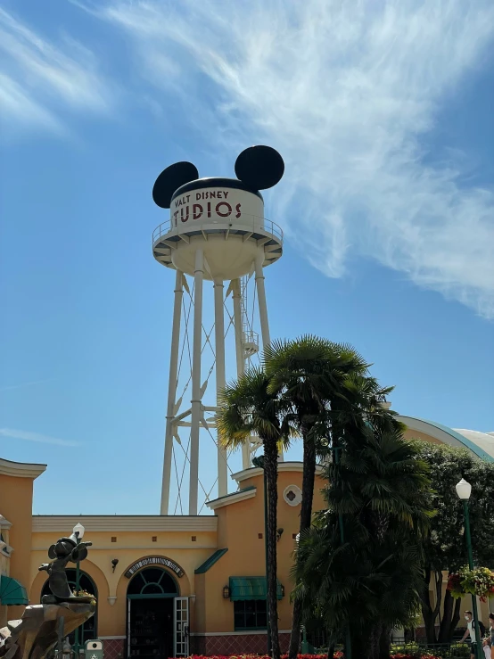 a disney resort with a water tower and entrance