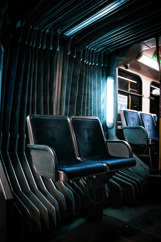 a train with two seats that have a dark blue leather seat