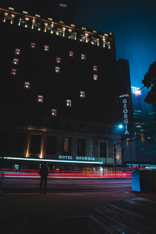 a building with windows at night with street lights