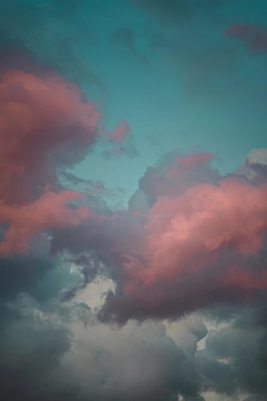 a red cloud sits in the blue sky