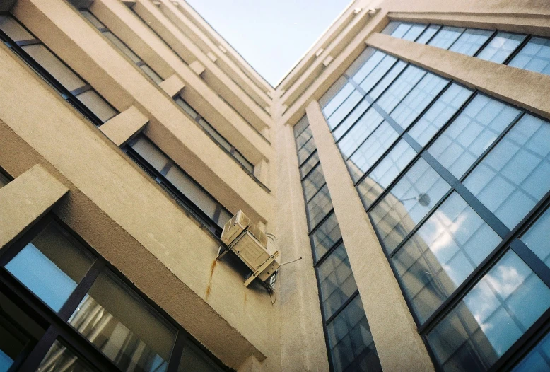 the outside of a building showing three windows and a sky view