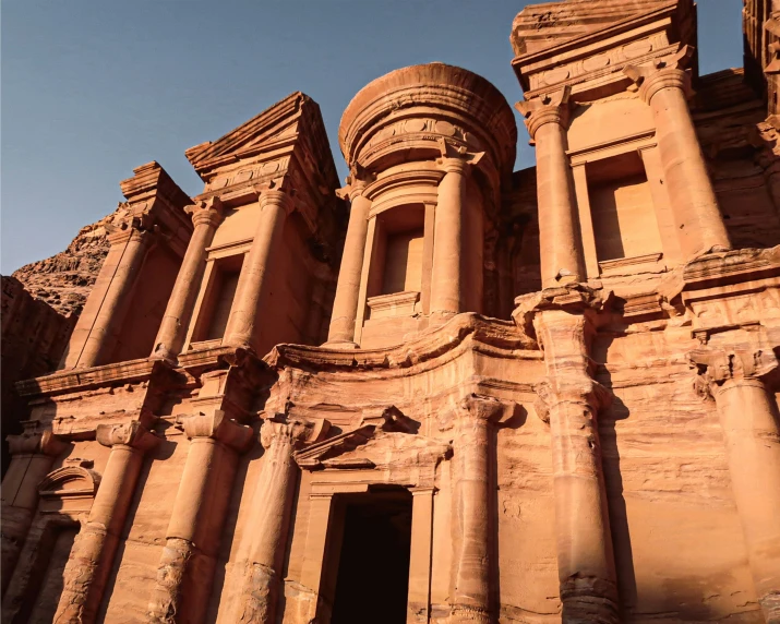 some stone pillars are in front of some rock