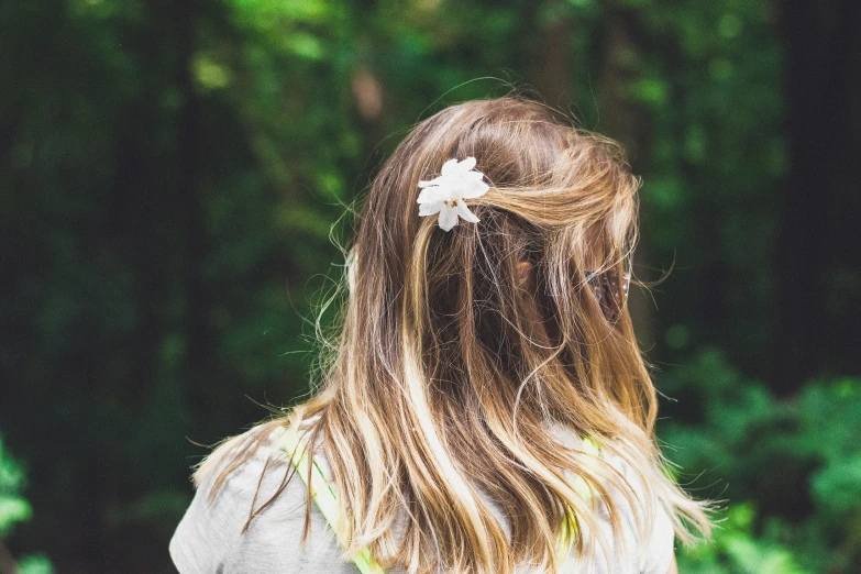 girl with flower in her hair looking back