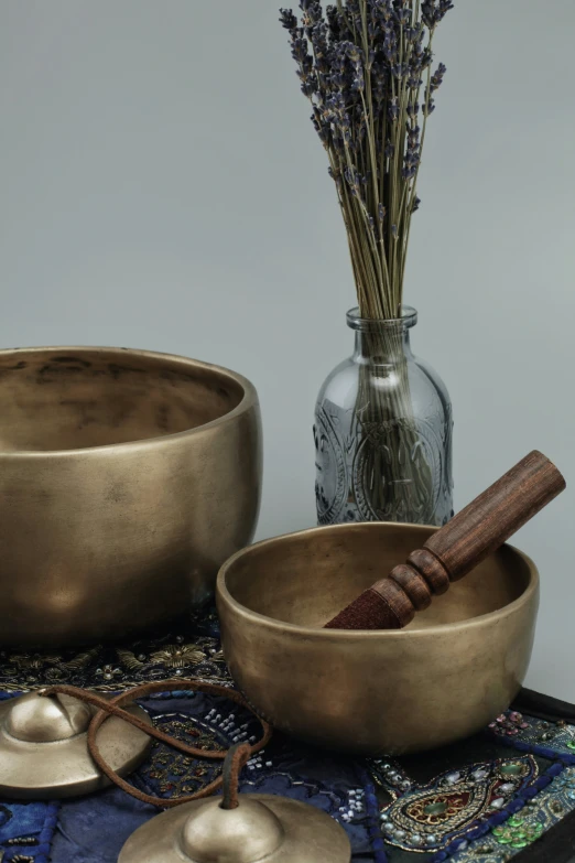 a table topped with two silver bowls filled with food