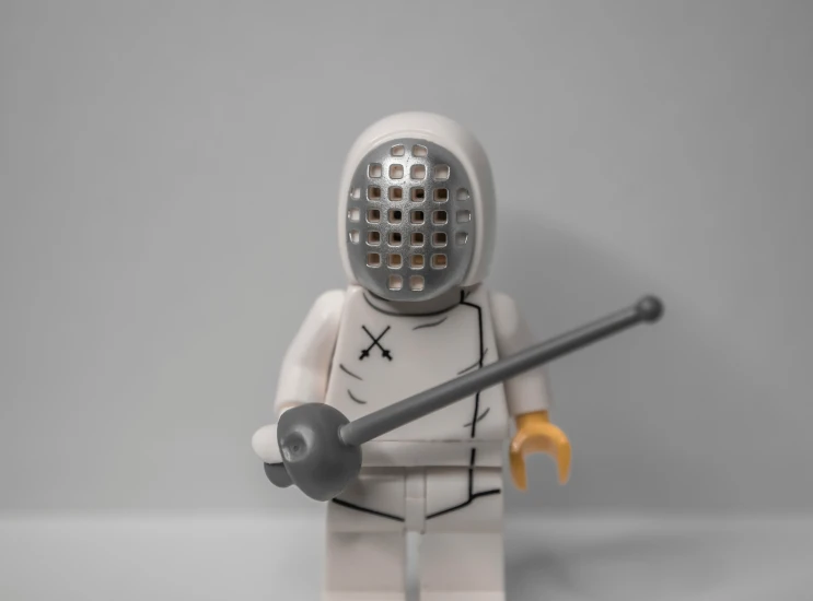 a lego figure is holding a large stick