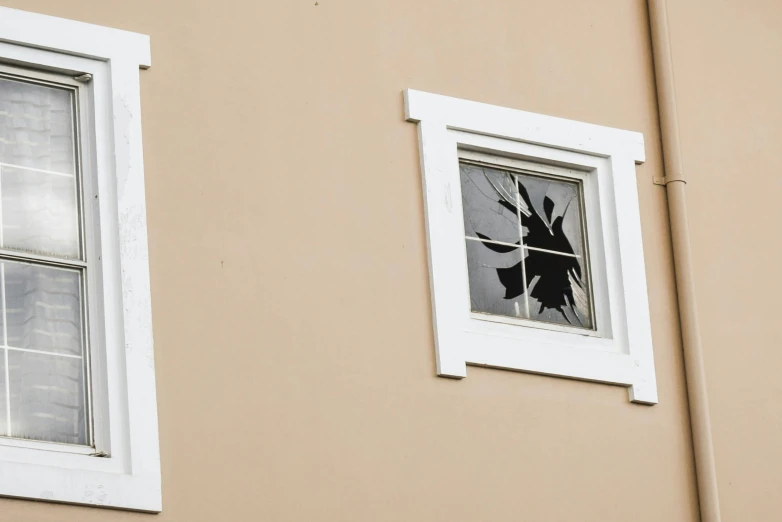 an open window with a broken glass in the reflection