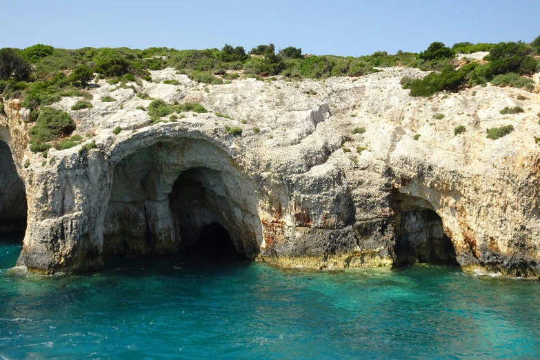 a rock formation with a cave at the bottom