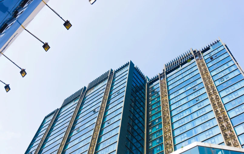 a building has several windows and traffic signals in front of it