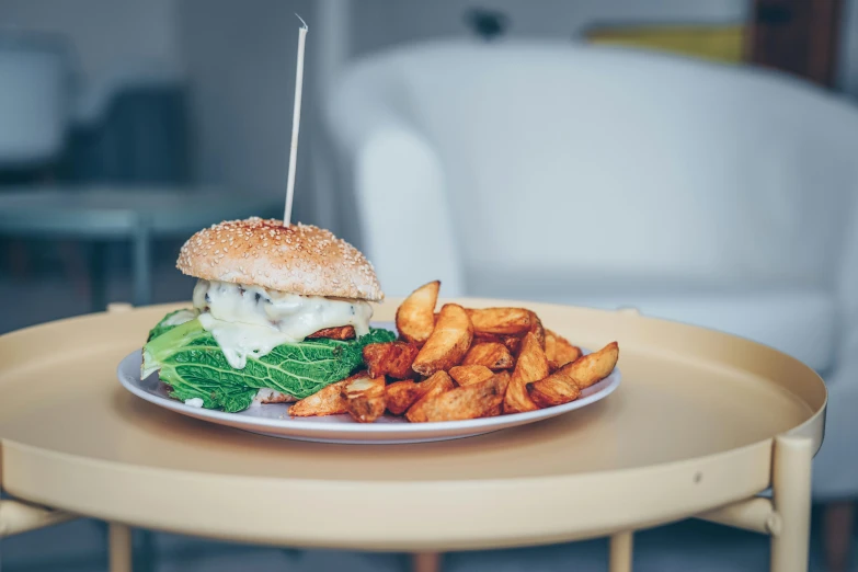 a sandwich on a plate with potato fries next to it