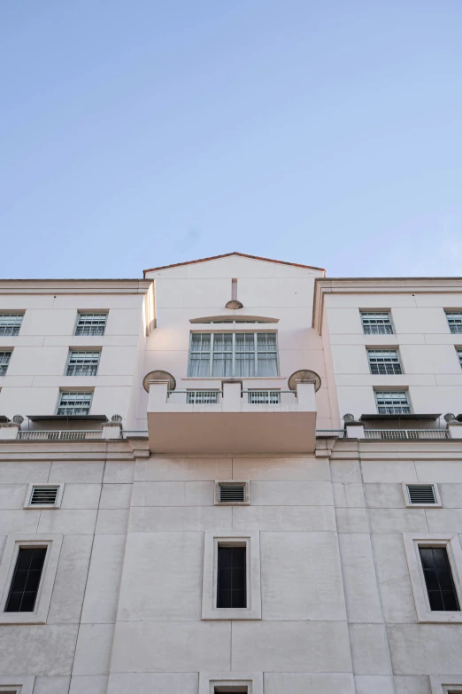 a tall white building with lots of windows