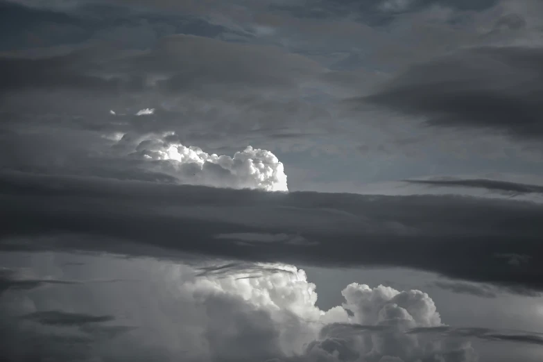 the view from a cloudy sky shows heavy clouds and birds