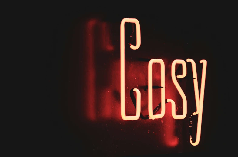 the word rosy lit up on the side of a neon sign