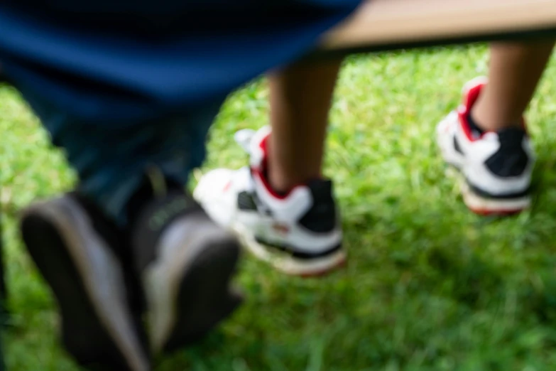 there are two people with sneakers in the grass