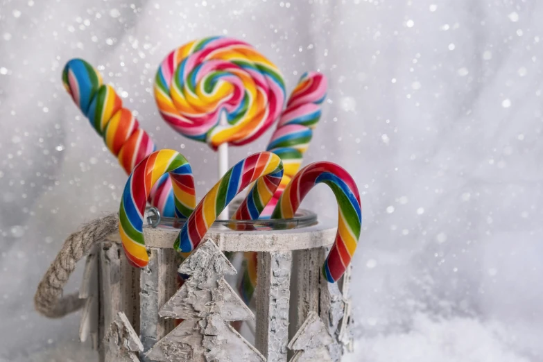 colorful lollipops in old candy tins on a snowy day