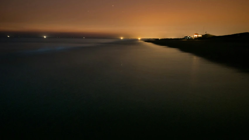 the shore at night and a small island in the distance