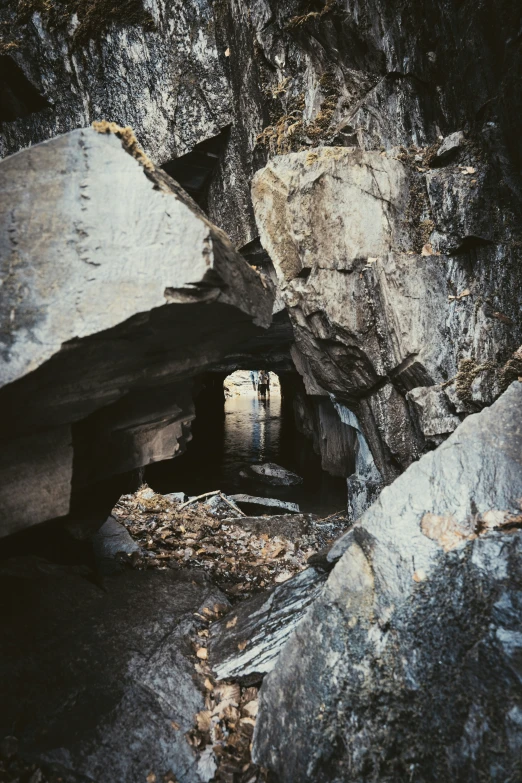 a very narrow hole in the rocks near a stone walkway