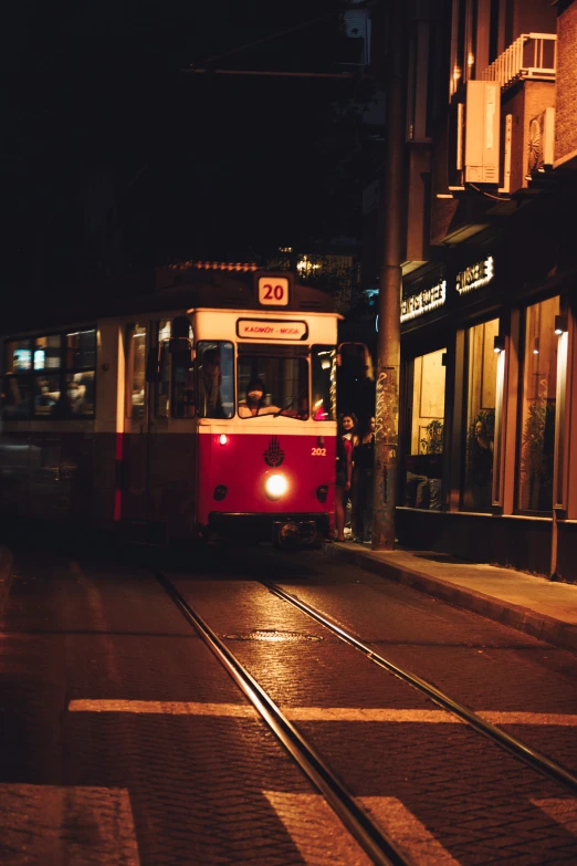 a light rail car drives down a city street