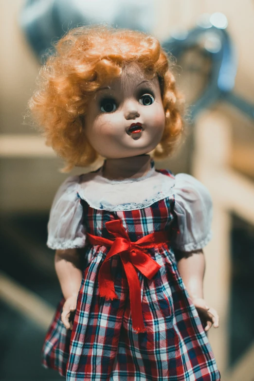 a creepy doll with red hair and makeup
